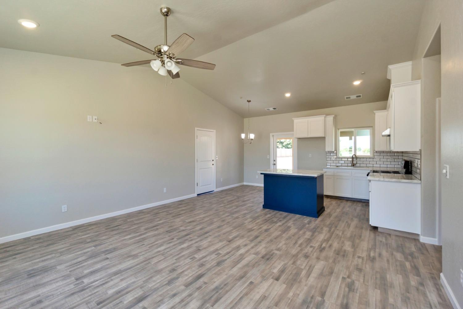 21250 Steward Road Madera, CA 93638 - Photo 25 of 40 a kitchen with kitchen island white cabinets and stainless steel appliances