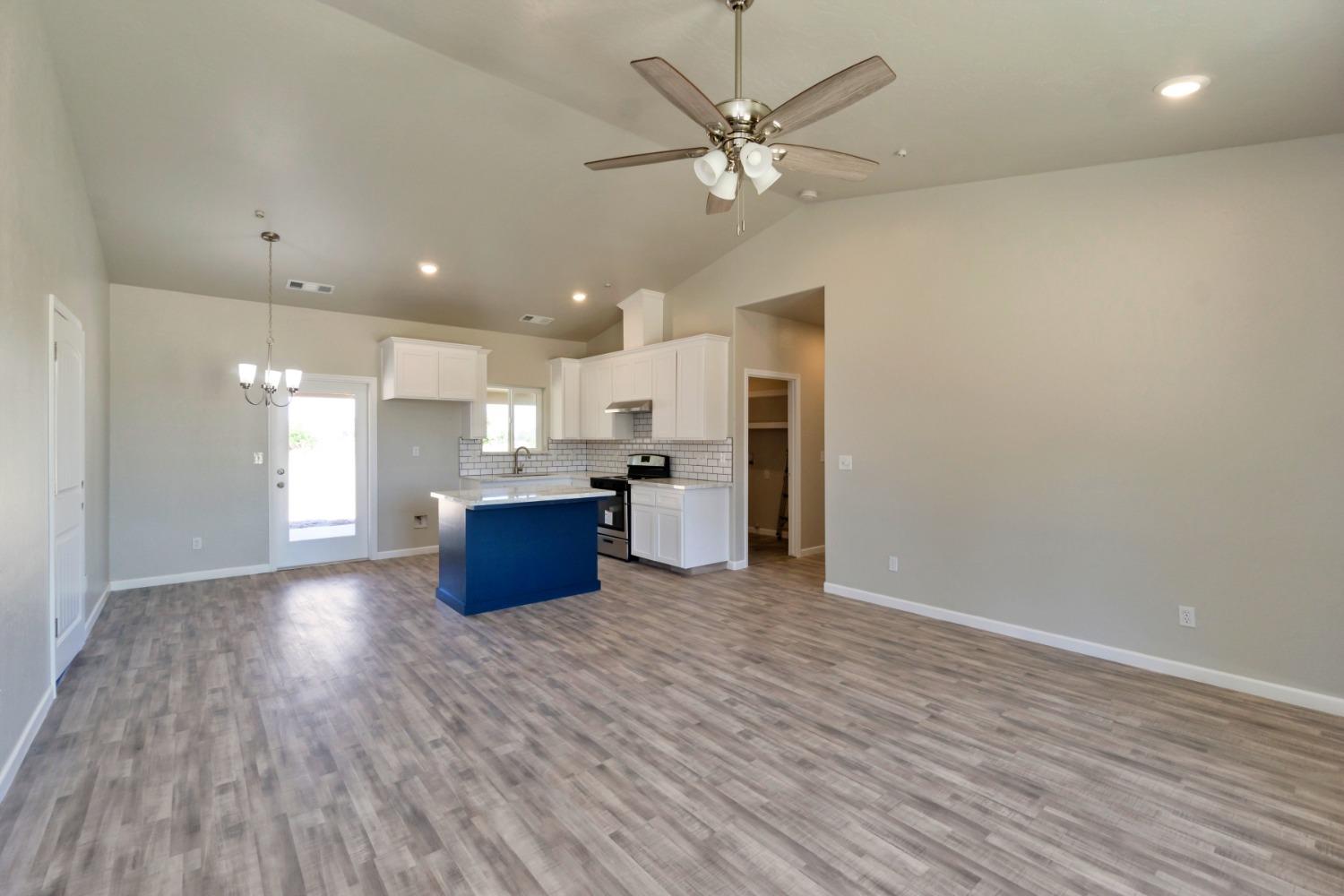 21250 Steward Road Madera, CA 93638 - Photo 26 of 40 a large kitchen with a lot of cabinets and wooden floor