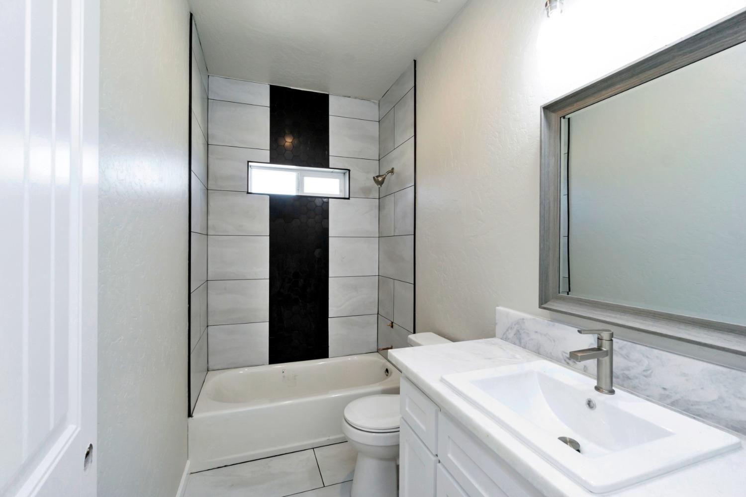 21250 Steward Road Madera, CA 93638 - Photo 30 of 40 a bathroom with a sink a toilet and shower