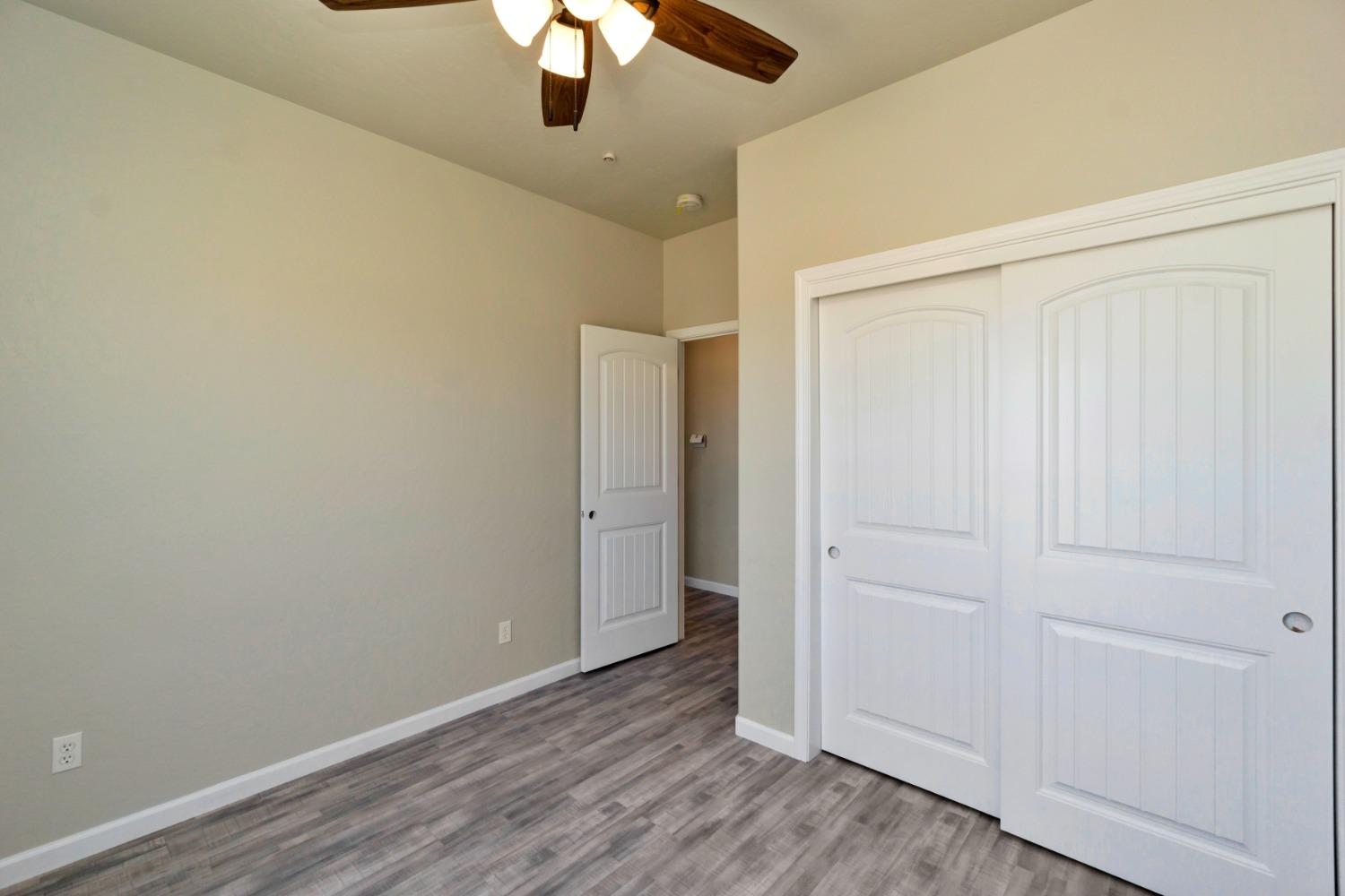 21250 Steward Road Madera, CA 93638 - Photo 33 of 40 an empty room with a hardwood and ceiling fan