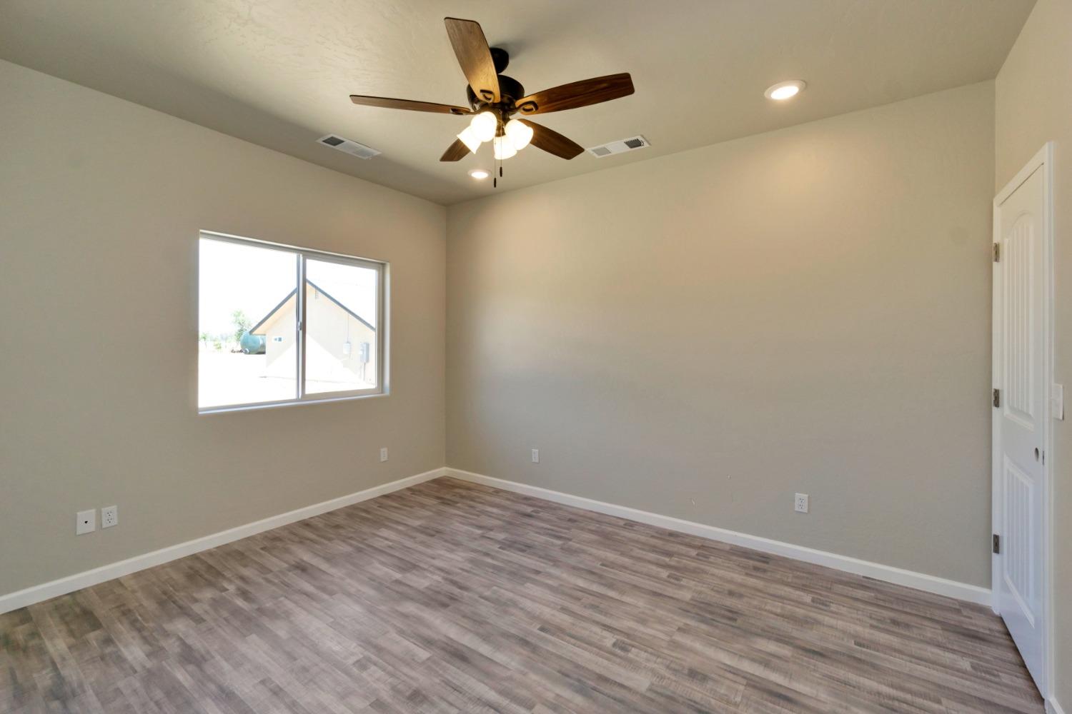 21250 Steward Road Madera, CA 93638 - Photo 35 of 40 wooden floor in an empty room with a window