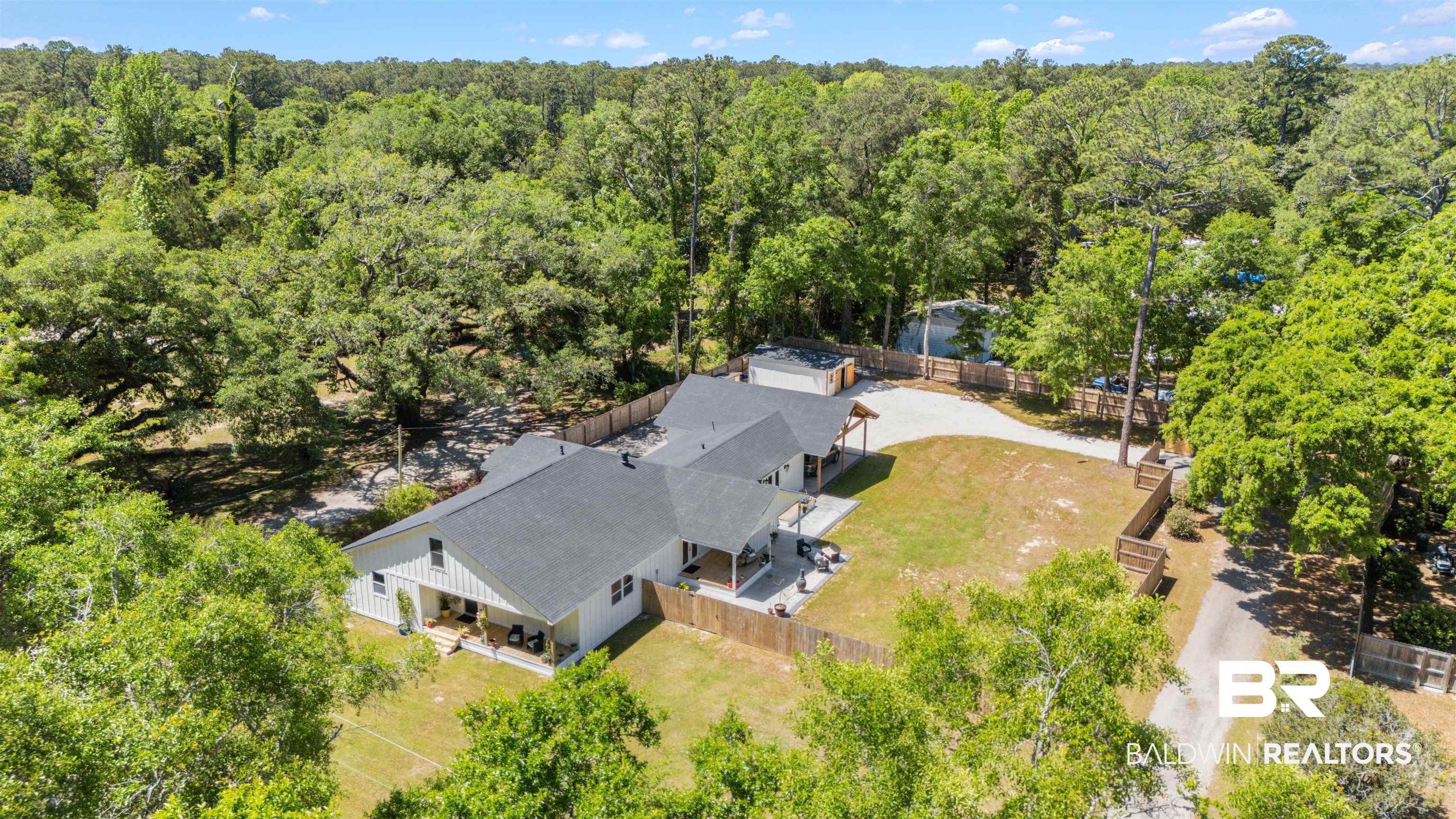 6447 Bemis Lane Bon Secour, AL 36511 - Photo 61 of 62 Expansive property featuring a single-story residence with white siding and dark roofing, surrounded by mature trees