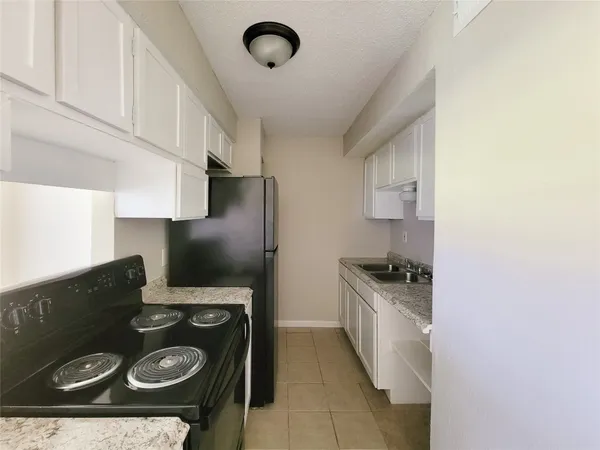a kitchen with a stove and a refrigerator