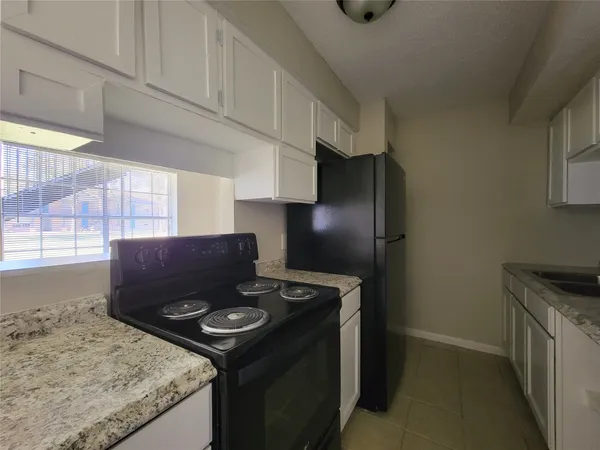 a kitchen with stainless steel appliances granite countertop a sink and cabinets