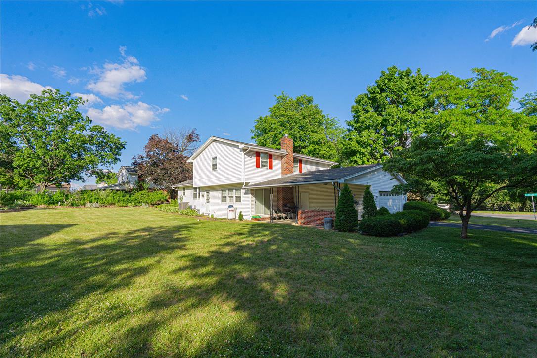 5425 Clauser Road Orefield, PA 18069 - Photo 13 of 18 A classic facade with a covered patio overlooks a generously sized yard, perfect for outdoor enjoyment.