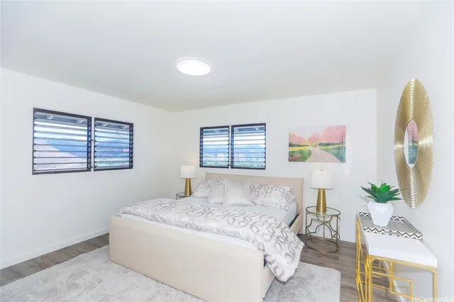 a bedroom with a bed and dresser with mirror