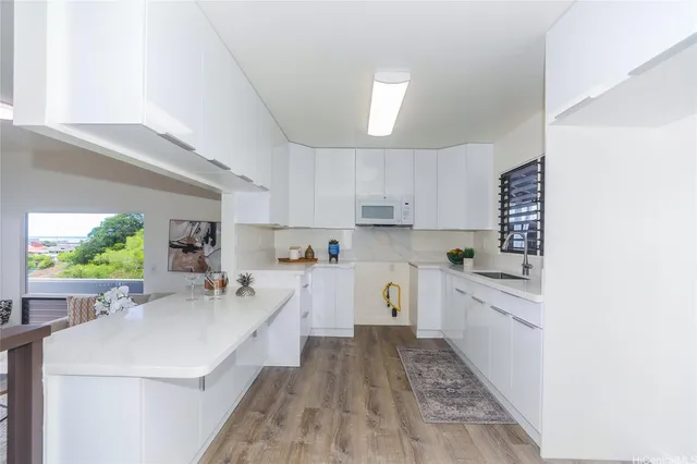 a kitchen with a sink stove and cabinets