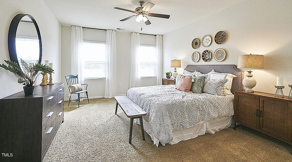 1733 Post Oak Drive Haw River, NC 27258 - Photo 13 of 26 a spacious bedroom with a bed and a chandelier