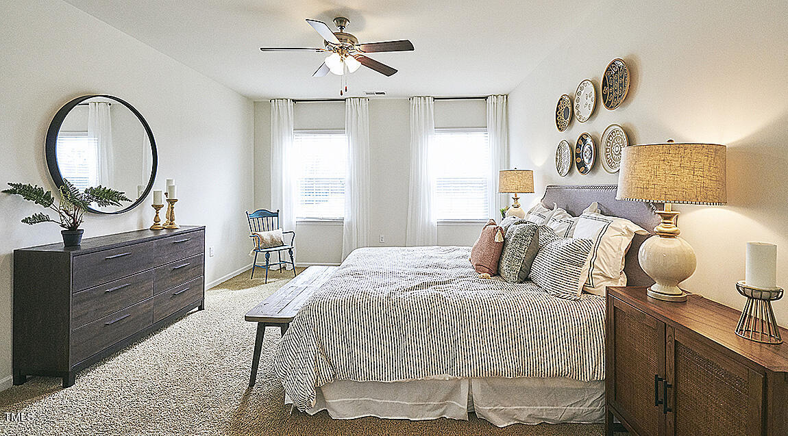 1733 Post Oak Drive Haw River, NC 27258 - Photo 14 of 26 a bedroom with a bed and a chandelier