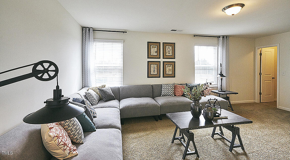1733 Post Oak Drive Haw River, NC 27258 - Photo 23 of 26 a living room with furniture a window and a table