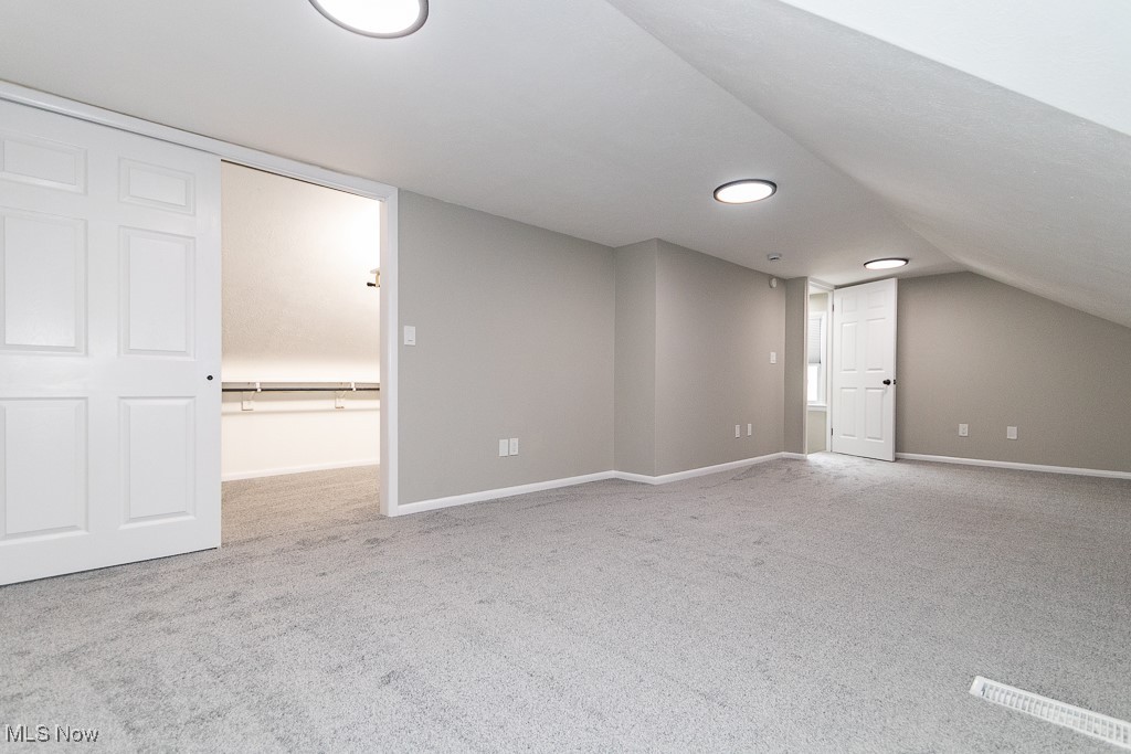 5683 Cherokee Road Cleveland, OH 44124 - Photo 22 of 35 Additional living space with light carpet and lofted ceiling