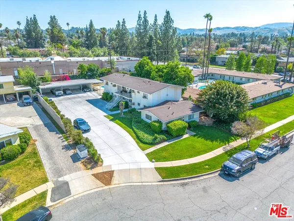 an aerial view of a house with garden space and street view