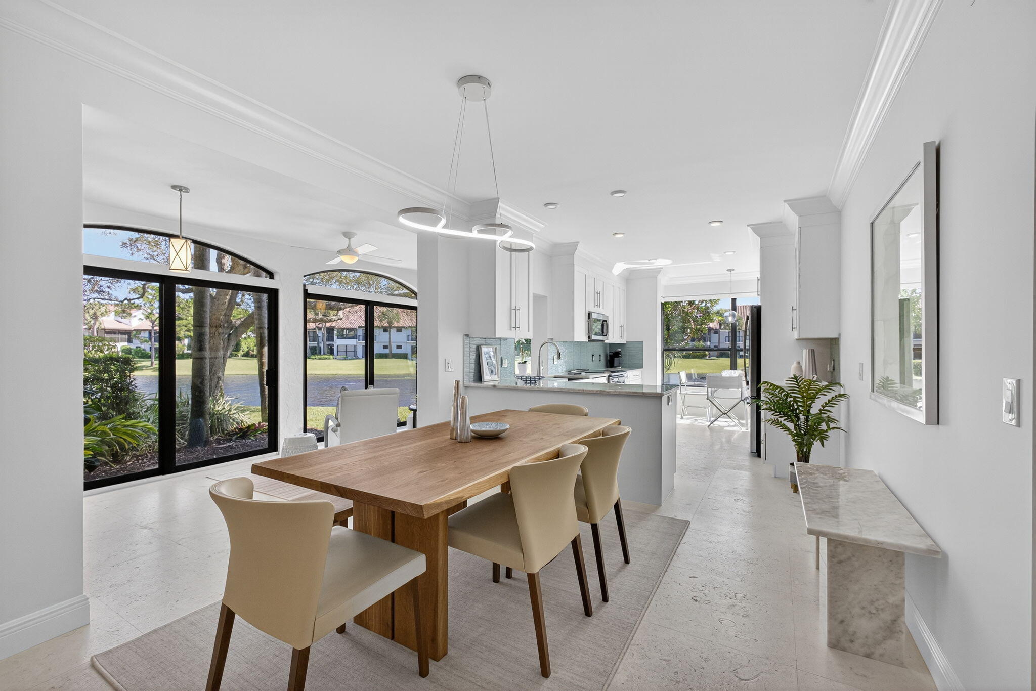 16050 West Bay Drive, Unit 155 Jupiter, FL 33477 - Photo 13 of 51 a view of a dining room with furniture large windows and wooden floor