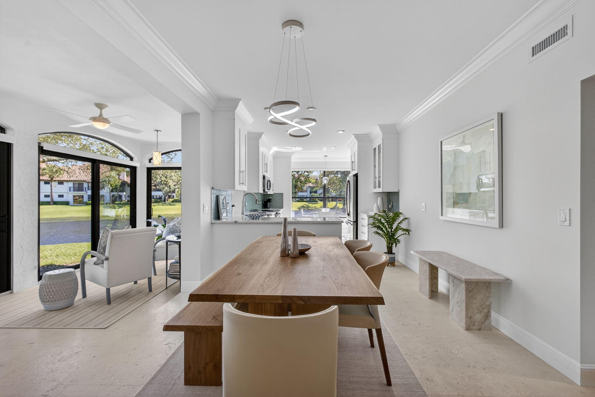 16050 West Bay Drive, Unit 155 Jupiter, FL 33477 - Photo 14 of 51 a dining room with wooden floor a chandelier a wooden table and chairs