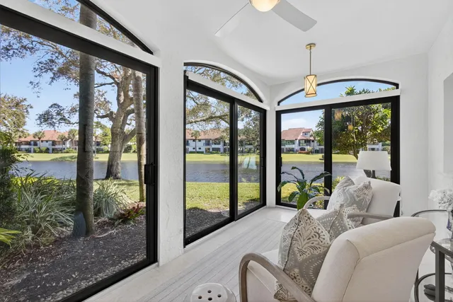a bedroom with furniture and large windows