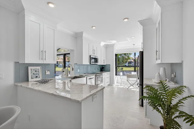 a kitchen with counter top space cabinets and stainless steel appliances