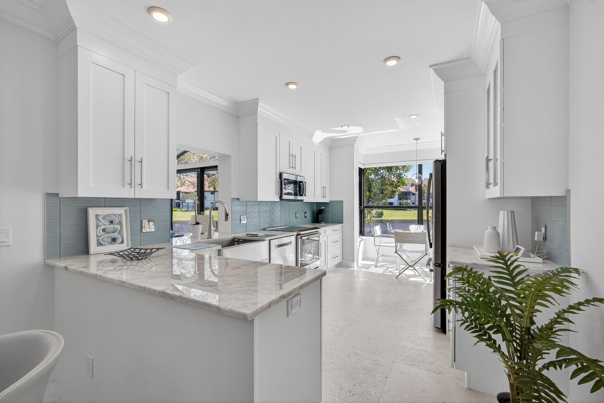 16050 West Bay Drive, Unit 155 Jupiter, FL 33477 - Photo 21 of 51 a kitchen with counter top space cabinets and stainless steel appliances