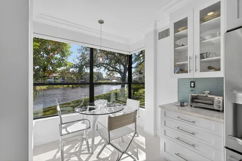 a view of a dining room with furniture large windows and wooden floor