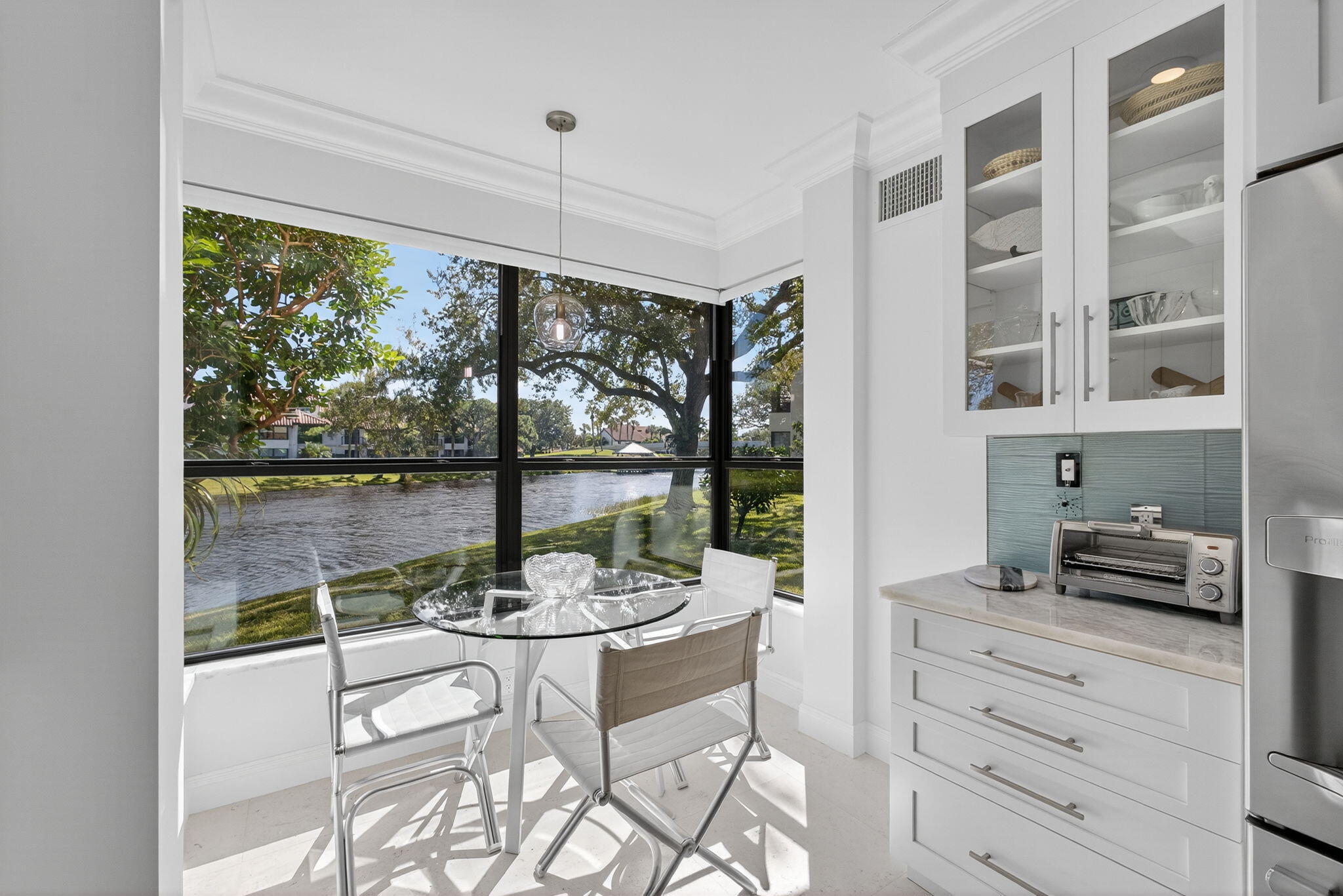 16050 West Bay Drive, Unit 155 Jupiter, FL 33477 - Photo 24 of 51 a view of a dining room with furniture large windows and wooden floor