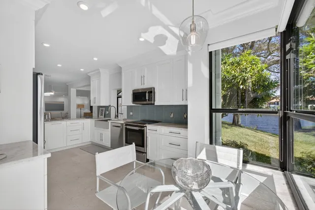 a kitchen with stainless steel appliances granite countertop a stove and cabinets