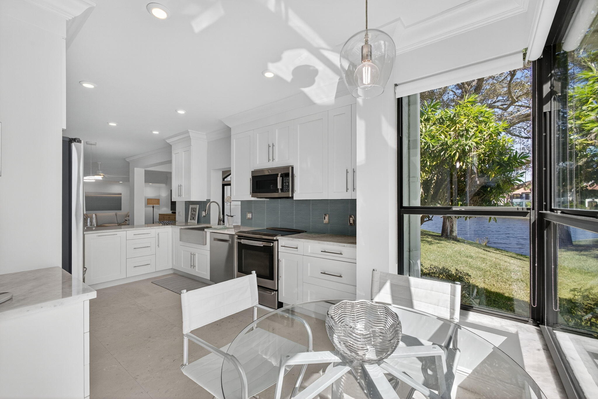 16050 West Bay Drive, Unit 155 Jupiter, FL 33477 - Photo 27 of 51 a kitchen with stainless steel appliances granite countertop a stove and cabinets