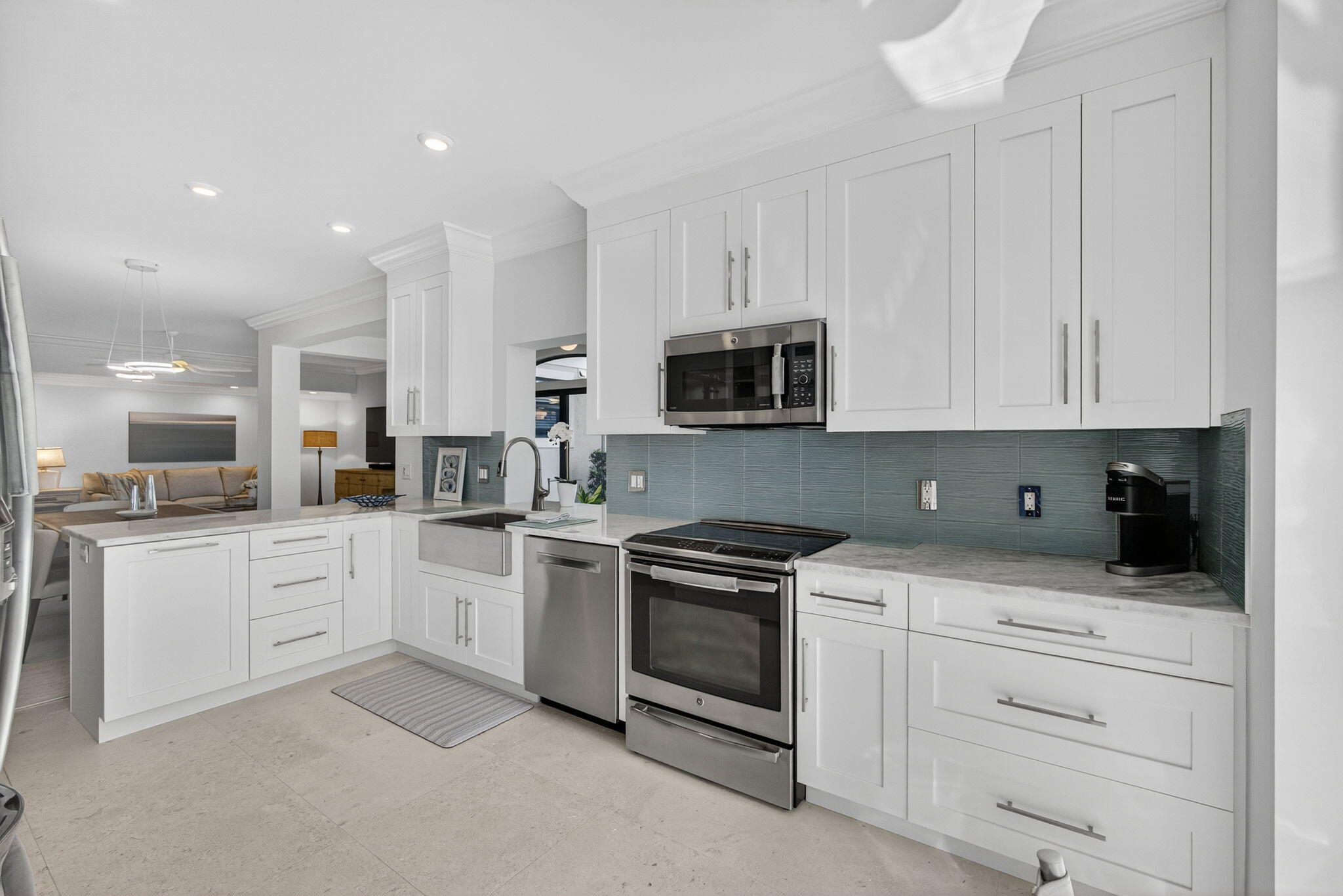 16050 West Bay Drive, Unit 155 Jupiter, FL 33477 - Photo 28 of 51 a kitchen with white cabinets stainless steel appliances and sink
