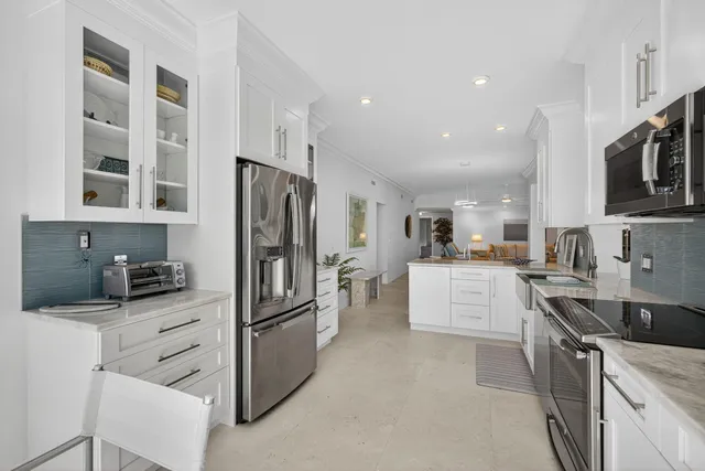 a kitchen with stainless steel appliances a refrigerator sink and stove