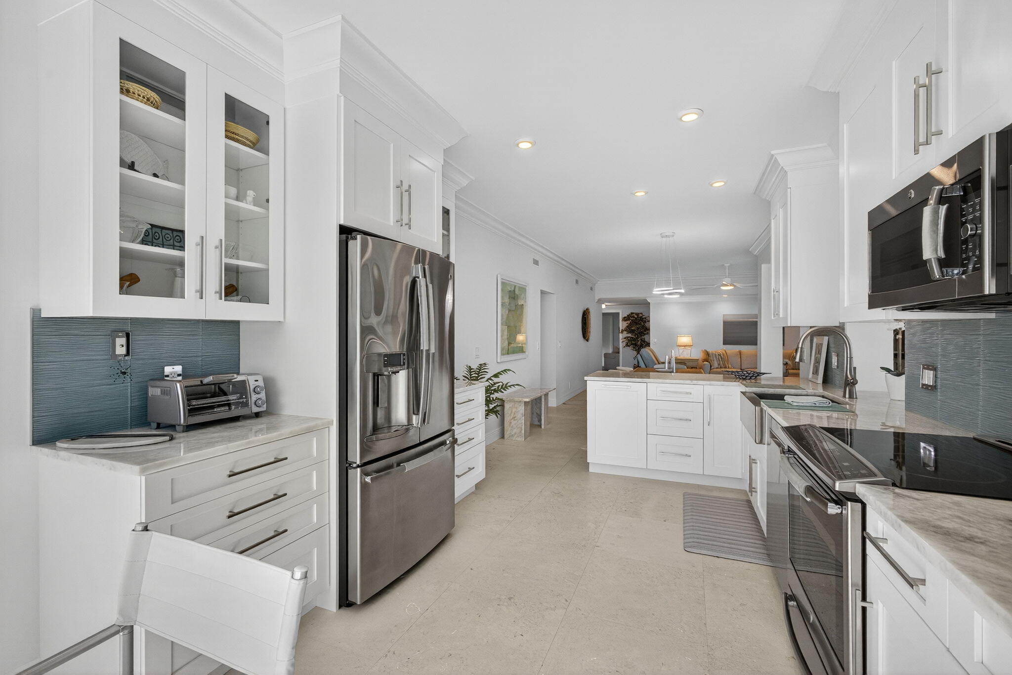 16050 West Bay Drive, Unit 155 Jupiter, FL 33477 - Photo 29 of 51 a kitchen with stainless steel appliances a refrigerator sink and stove