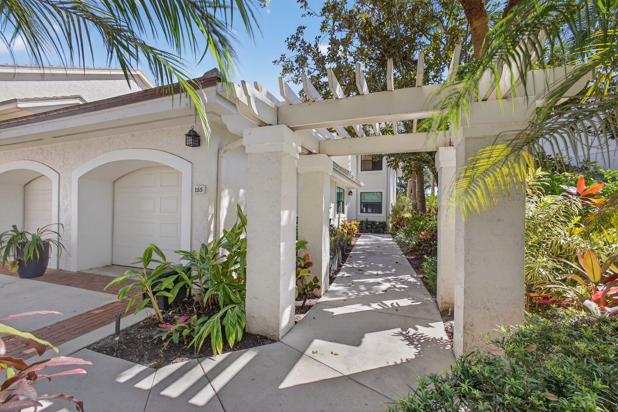 16050 West Bay Drive, Unit 155 Jupiter, FL 33477 - Photo 3 of 51 a front view of a house with a porch