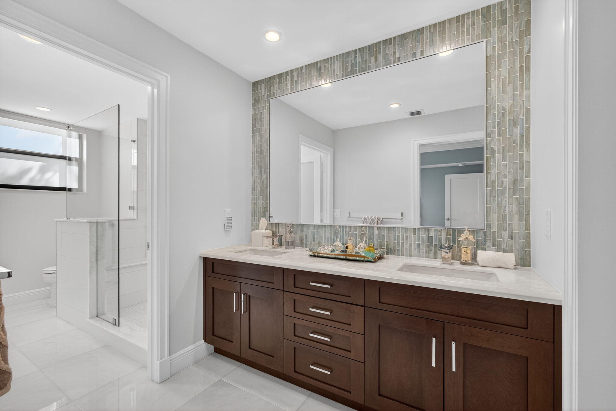 16050 West Bay Drive, Unit 155 Jupiter, FL 33477 - Photo 32 of 51 a bathroom with double vanity sinks and a mirror