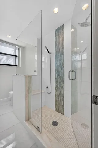 a bathroom with a shower and a sink