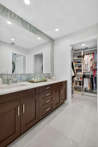 a spacious bathroom with a double vanity sink double and a mirror