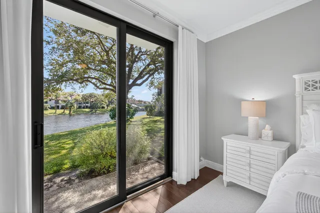 a bedroom with a bed and a large window