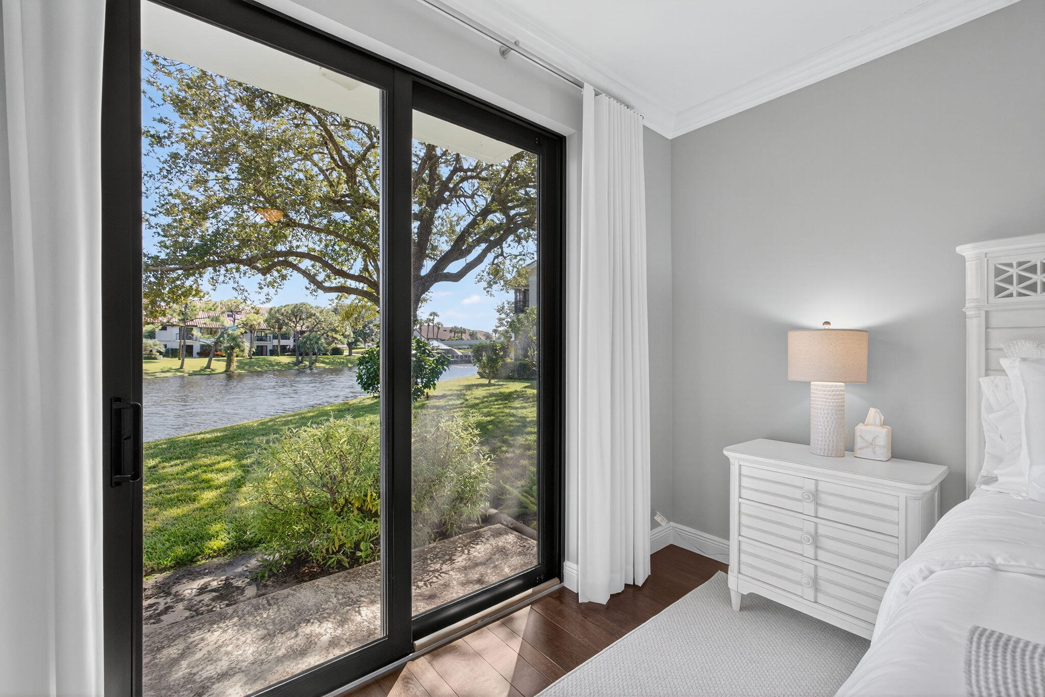 16050 West Bay Drive, Unit 155 Jupiter, FL 33477 - Photo 37 of 51 a bedroom with a bed and a large window