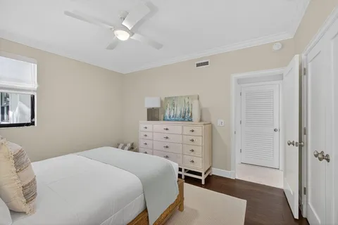 a bedroom with a bed and a chandelier fan