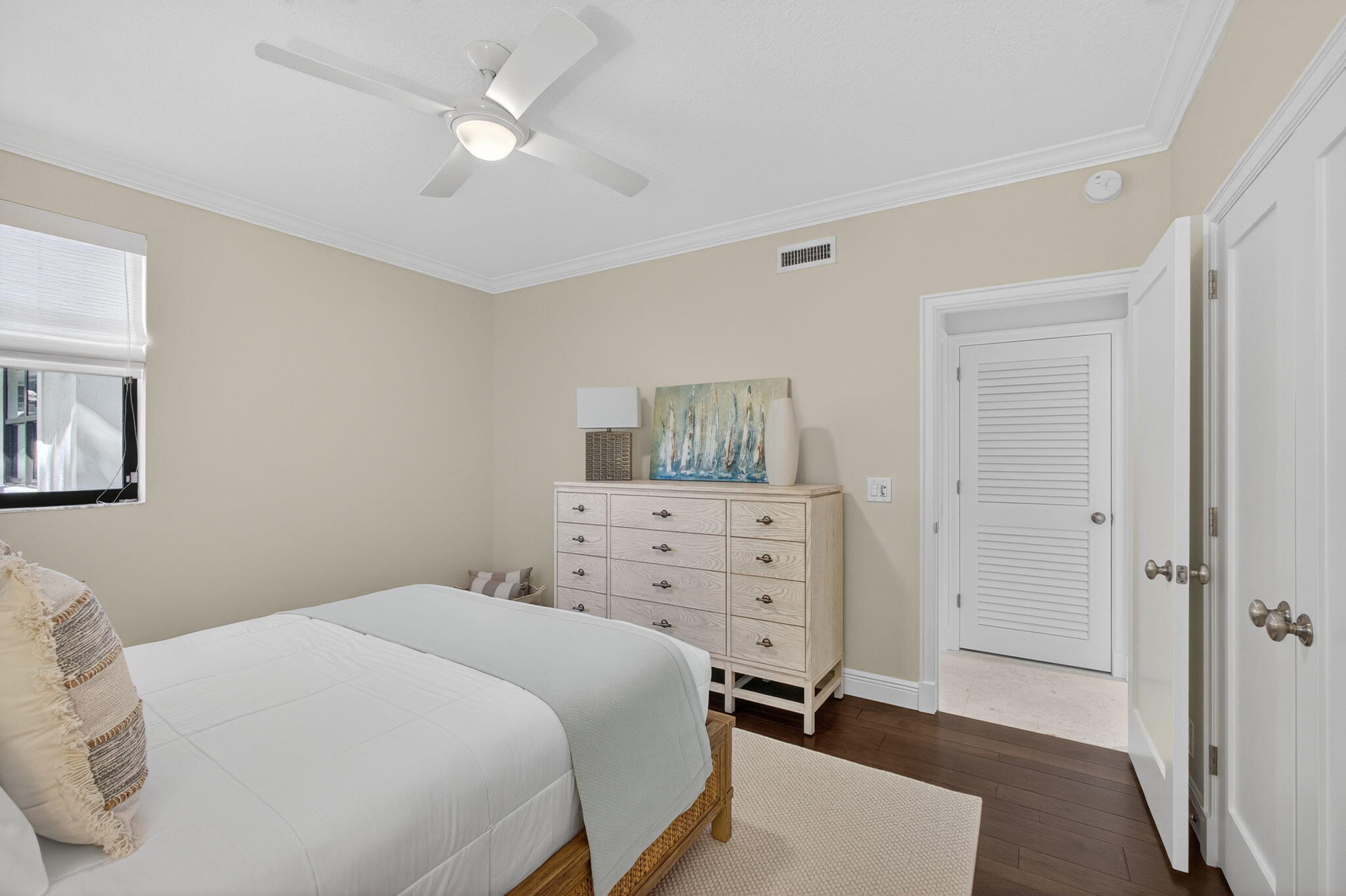 16050 West Bay Drive, Unit 155 Jupiter, FL 33477 - Photo 39 of 51 a bedroom with a bed and a chandelier fan