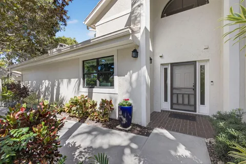 a view of a house with potted plants