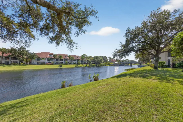 a view of a lake with houses in the background