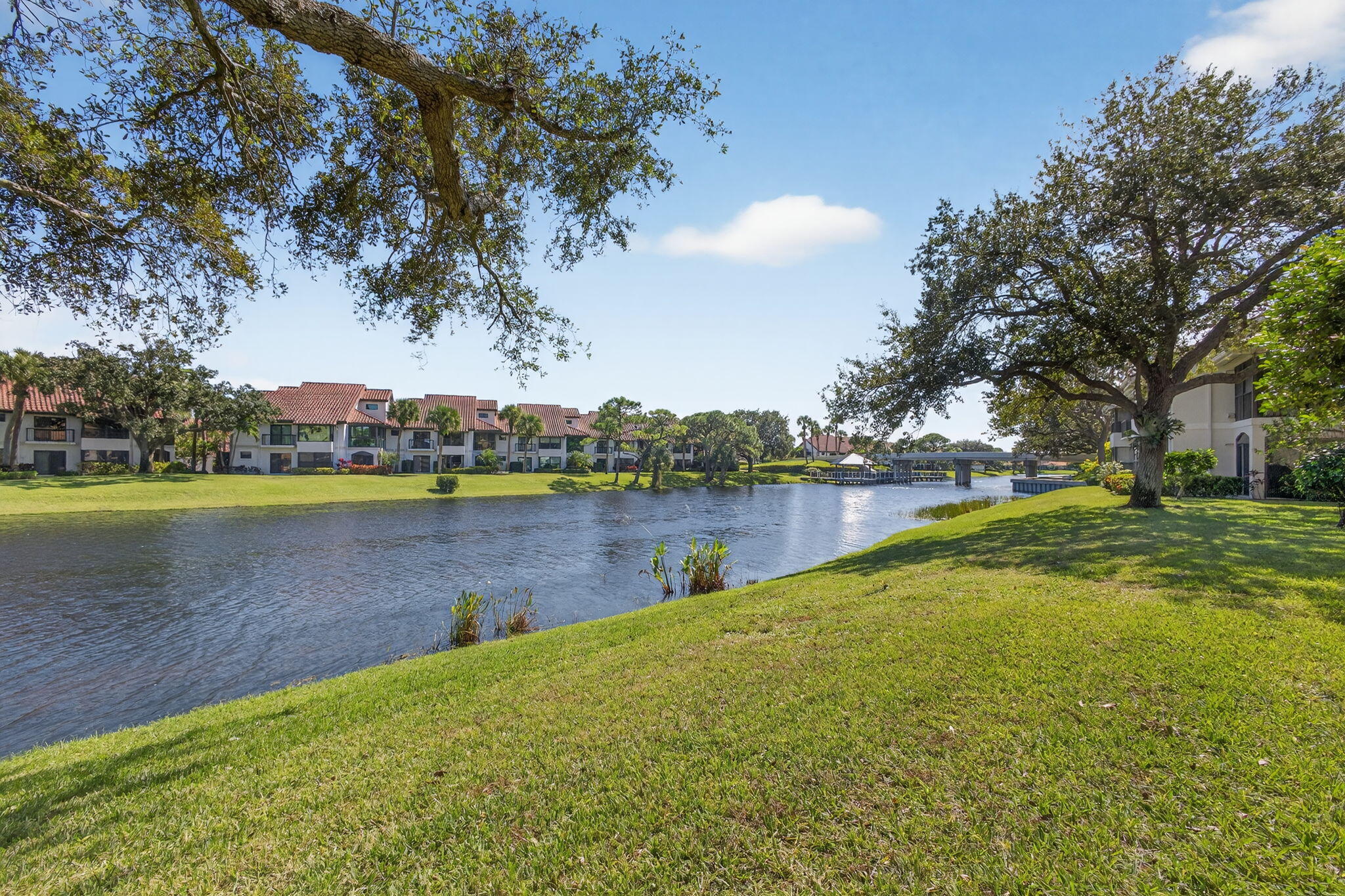 16050 West Bay Drive, Unit 155 Jupiter, FL 33477 - Photo 42 of 51 a view of a lake with houses in the background