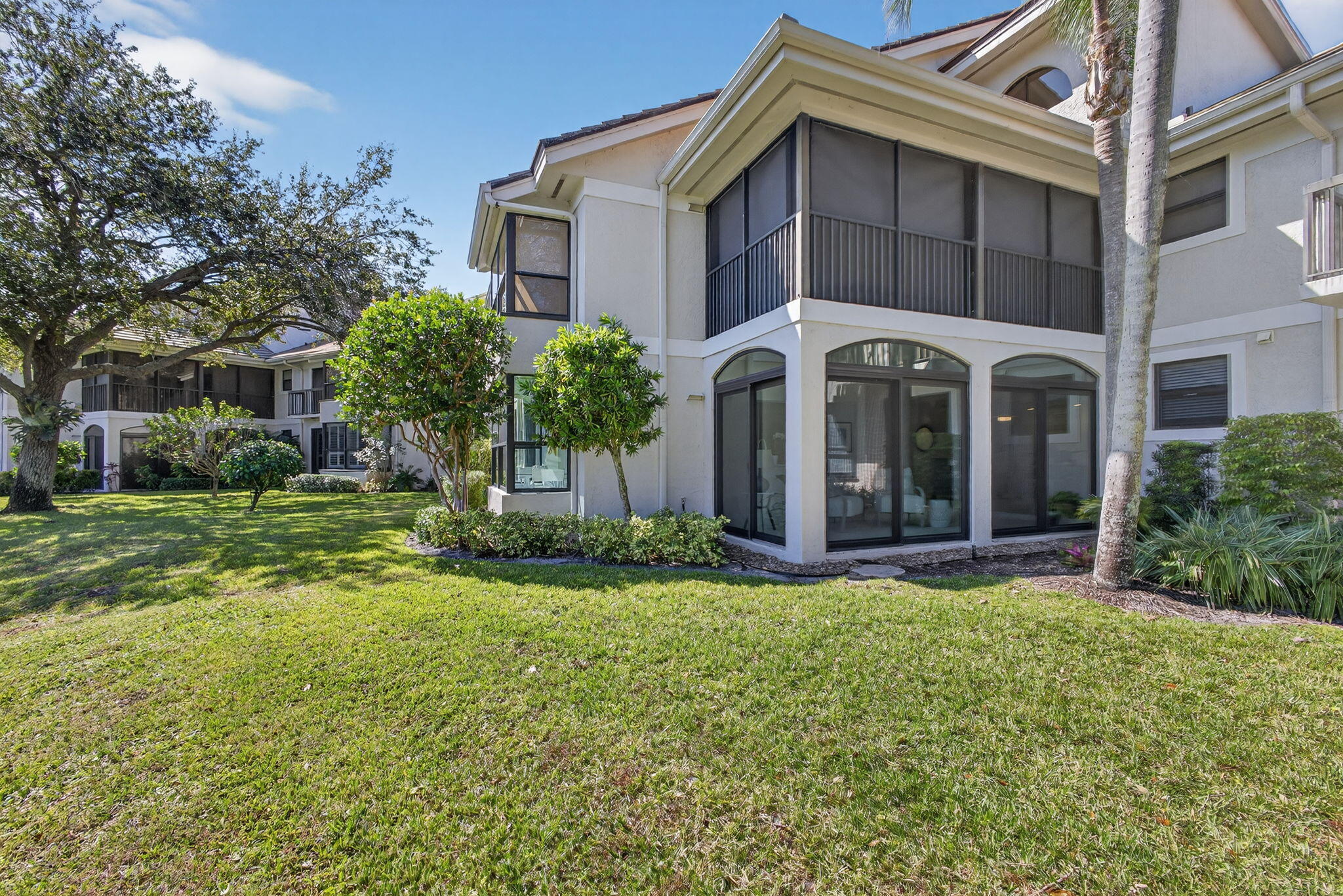 16050 West Bay Drive, Unit 155 Jupiter, FL 33477 - Photo 43 of 51 a front view of a house with a yard and garage