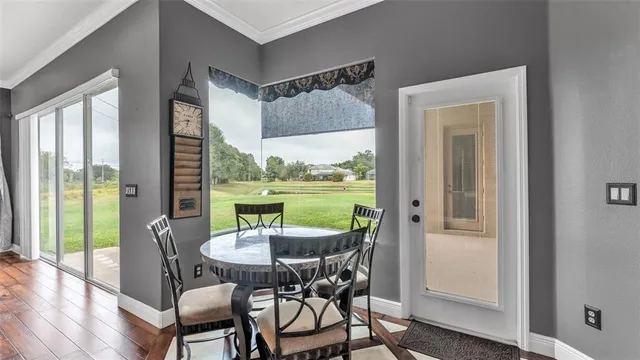 a view of a livingroom with a ceiling fan and wooden floor