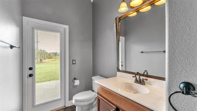 a bathroom with a shower a mirror and a toilet