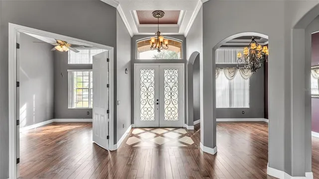 a view of empty room with window and wooden floor