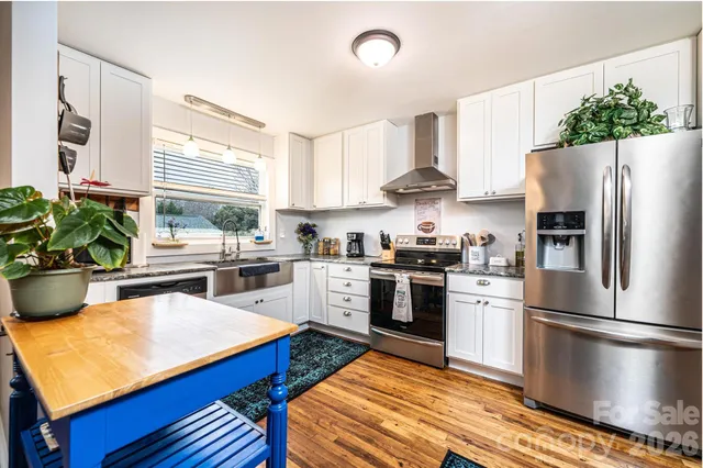 a kitchen with stainless steel appliances a refrigerator sink and stove