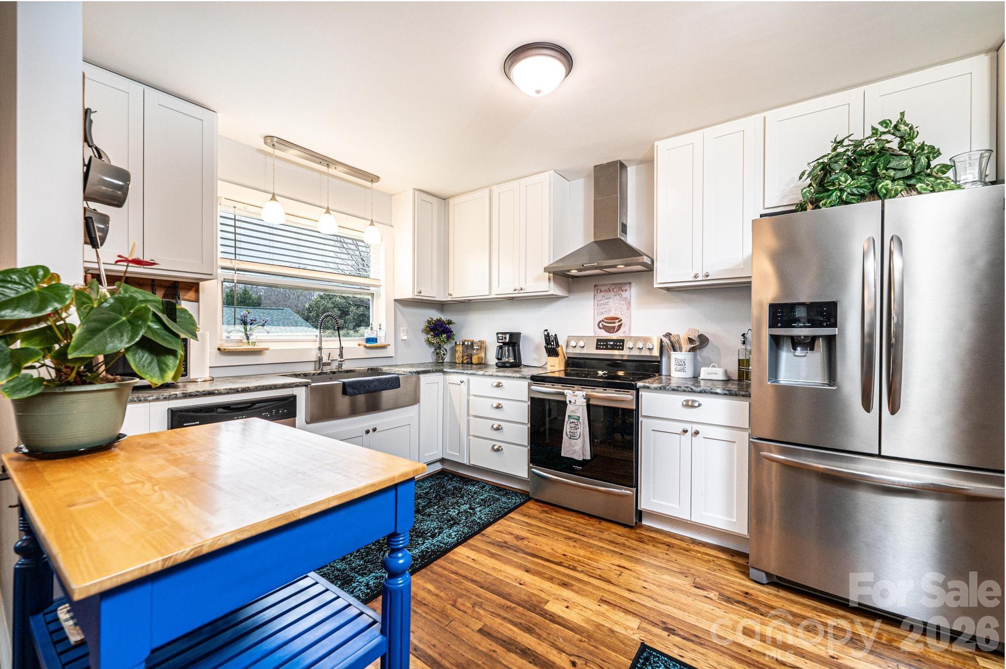 235 Spring Street Mocksville, NC 27028 - Photo 12 of 41 a kitchen with stainless steel appliances a refrigerator sink and stove