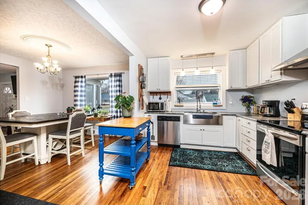 a kitchen with stainless steel appliances granite countertop a stove and a refrigerator