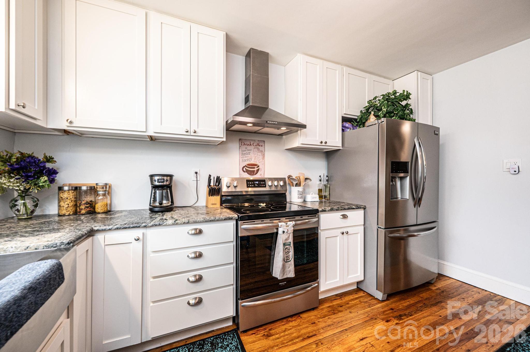 235 Spring Street Mocksville, NC 27028 - Photo 14 of 41 a kitchen with stainless steel appliances granite countertop a stove a refrigerator and a refrigerator