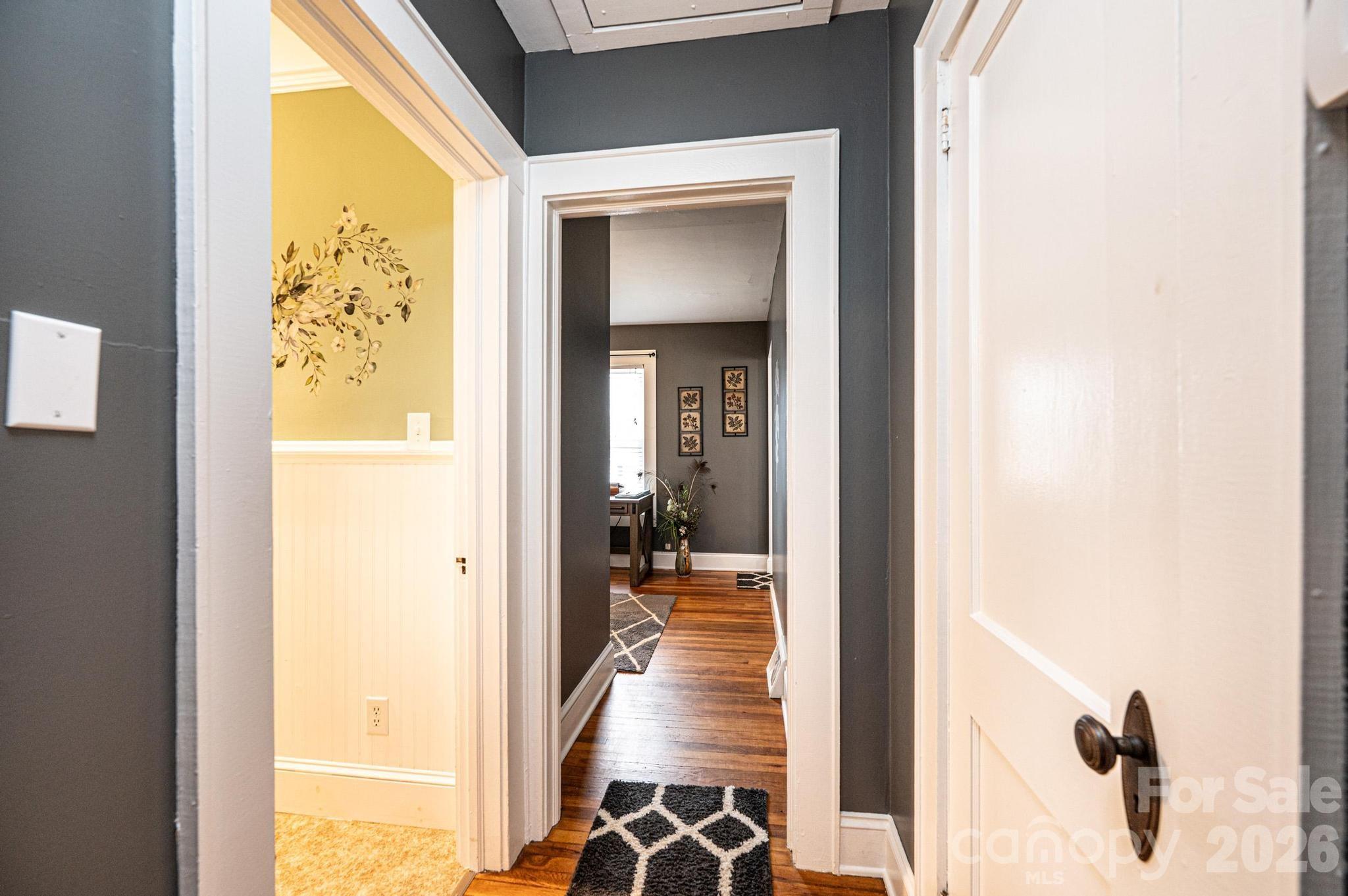 235 Spring Street Mocksville, NC 27028 - Photo 18 of 41 a view of a hallway with wooden floor and a dining room
