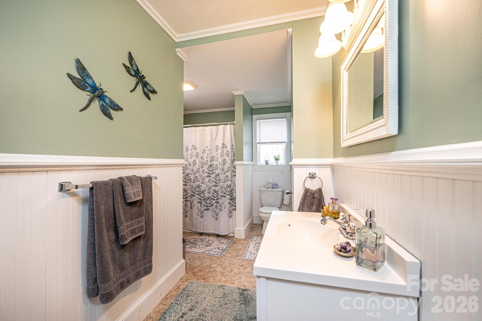235 Spring Street Mocksville, NC 27028 - Photo 19 of 41 a bathroom with a sink a mirror and a shower