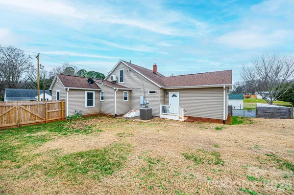 a backyard of a house with wooden floor and fence
